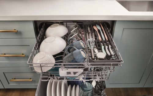  Open dishwasher with dishes on each rack