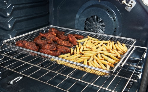 Chicken and fries in an air fryer basket