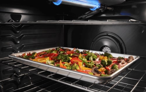 Veggies roasting on a pan in a convection oven