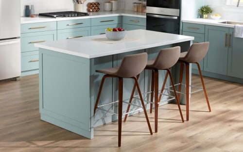 Three stools nestled into a kitchen island