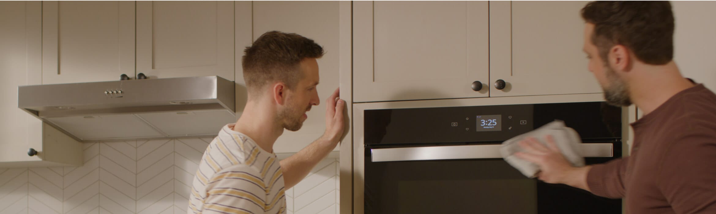 Two people installing a Whirlpool® Wall Oven