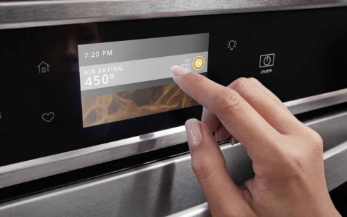 A closeup of a person programming a Whirlpool® oven with Air Fry Mode.