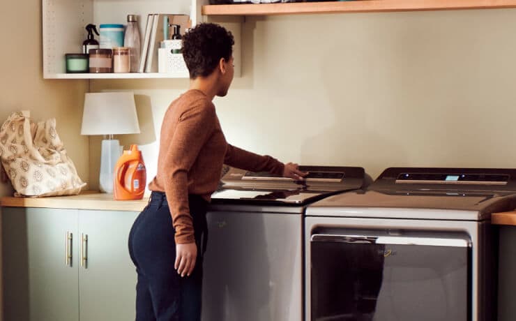 A person starting the washer