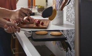 Pancakes being flipped over an induction cooktop