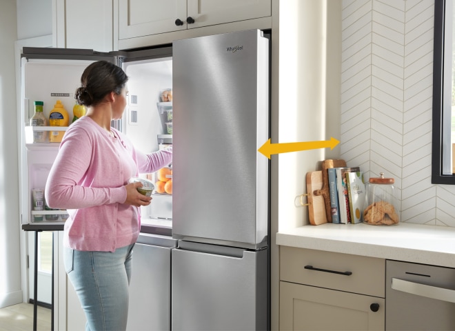 A person opening their refrigerator