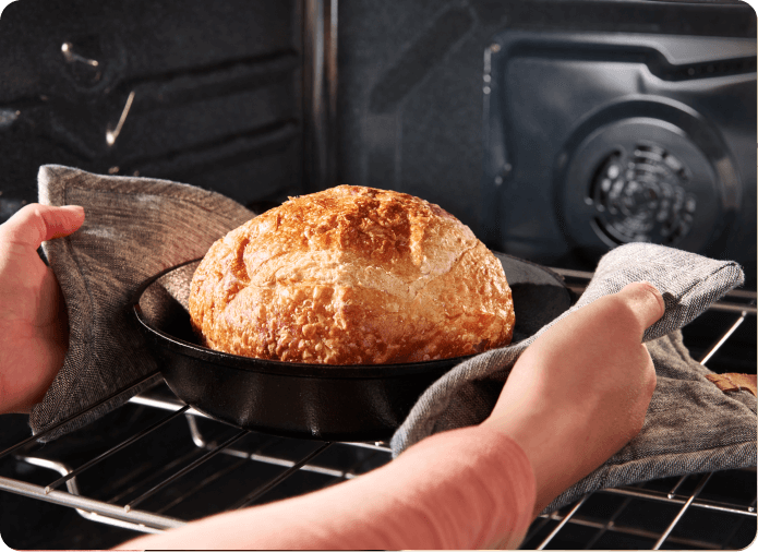 Loaf of bread cooking inside the oven.