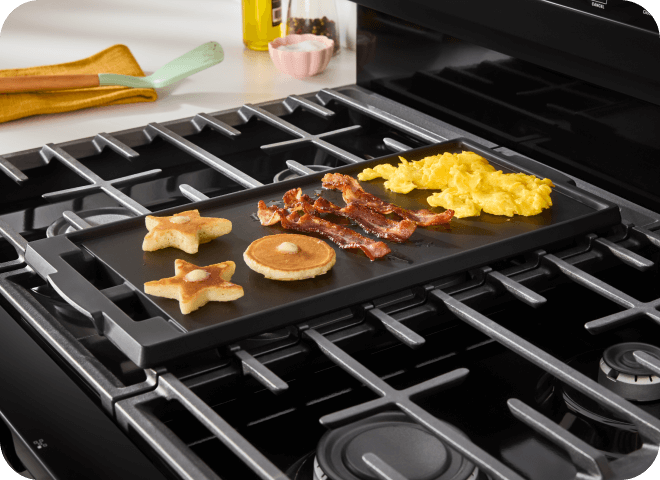 Breakfast items cooking on a griddle on a Whirlpool® Range