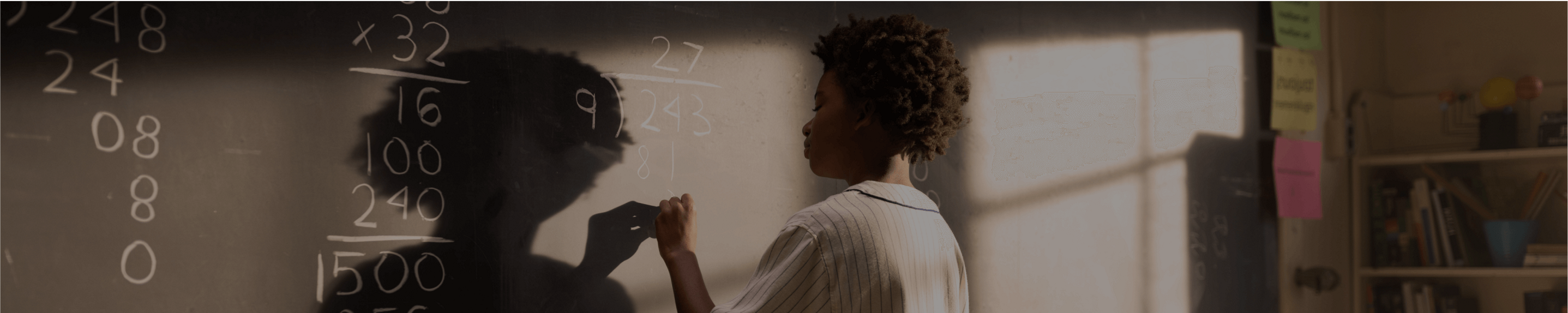 Student writing on a chalkboard