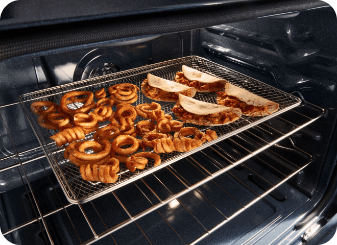 Curly fries and quesadillas being air fried in the oven