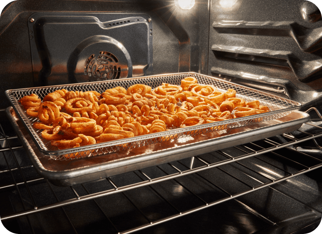 Curly fries being air fried in a Whirlpool® Range Oven