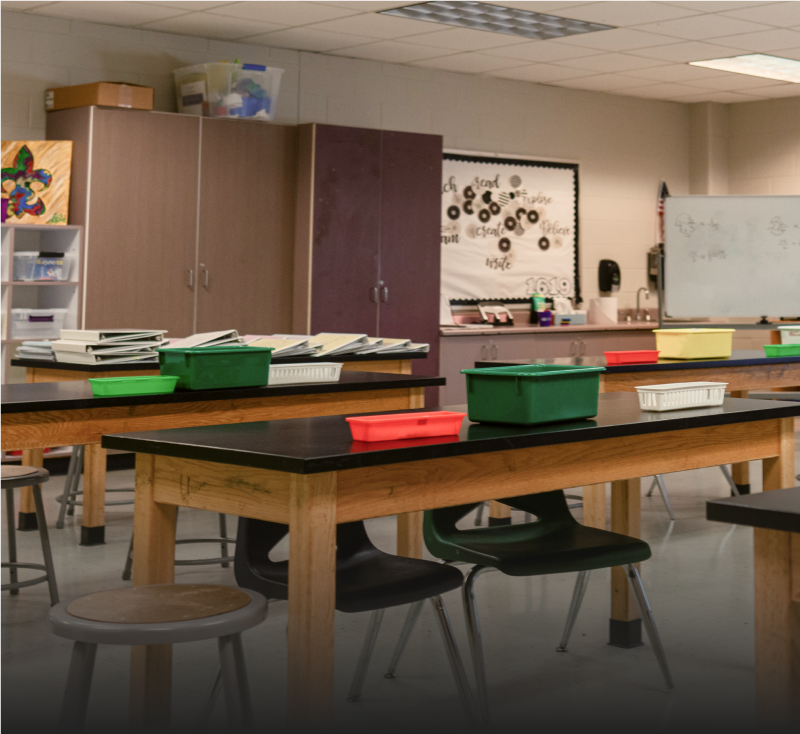 A row of empty desks in a school classroom