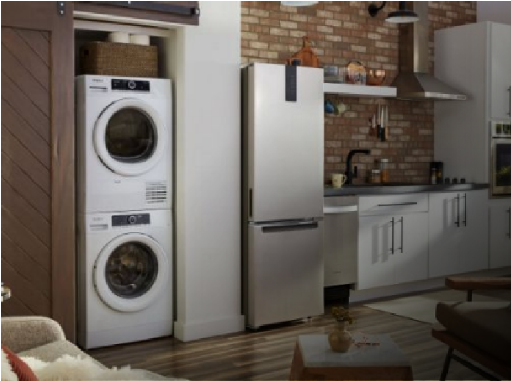 A kitchen with light cabinets and small space appliances