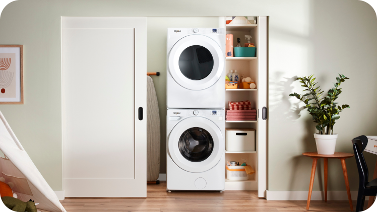 A Whirlpool® Stacked Laundry Center in a closet