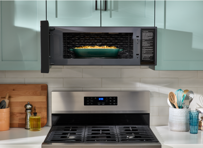 A Whirlpool® Low Profile Microwave with a dish inside.