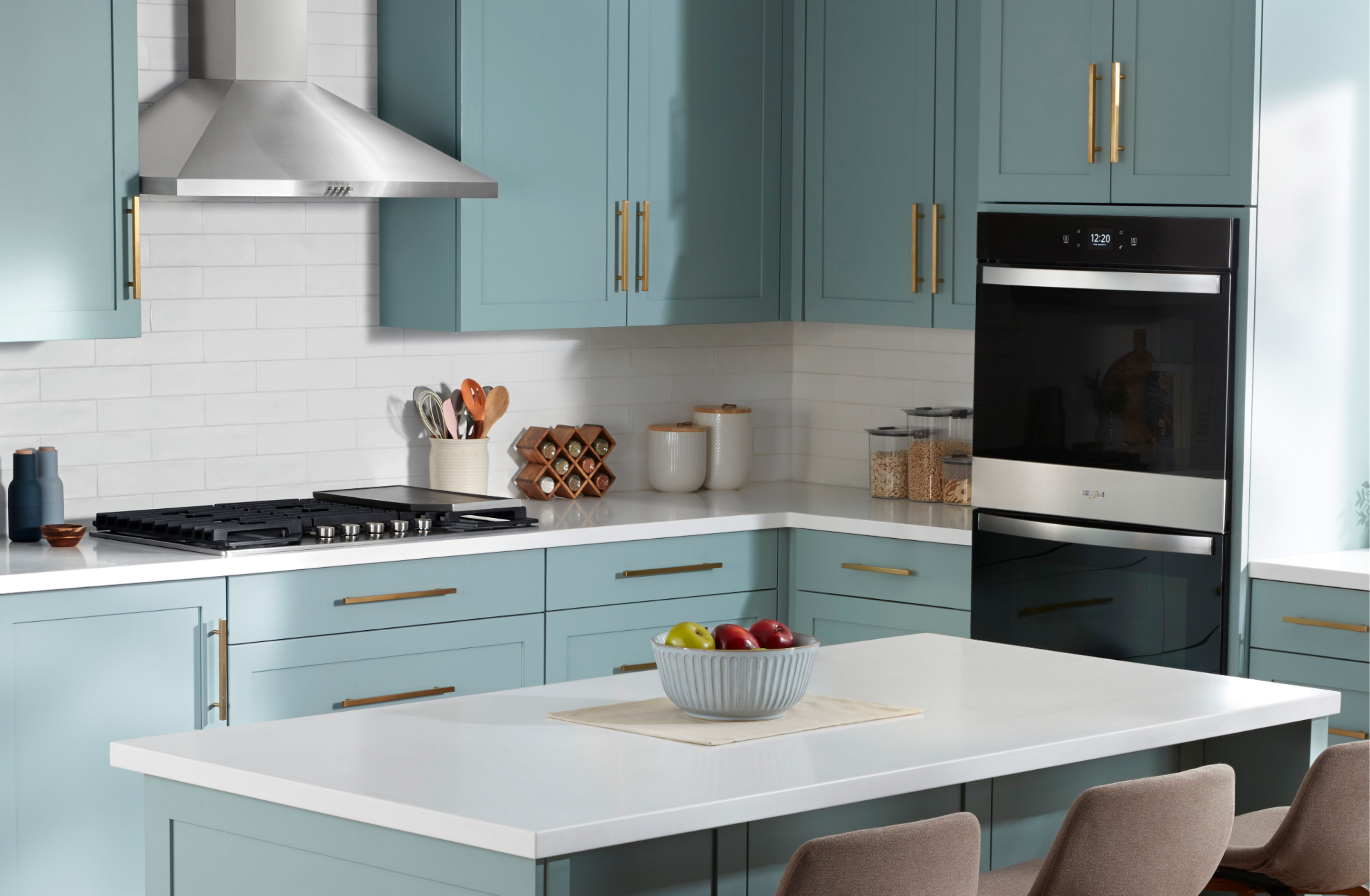 Whirlpool® appliances in a kitchen with light blue cabinets.